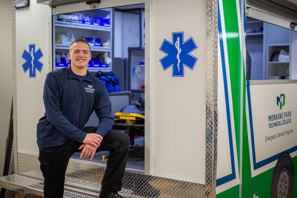 Abel Kooima standing in front of an EMT vehicle.