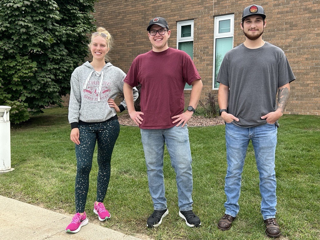 Charles Dreher standing in between two other West Bend campus student senate officers.