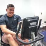 Health and Wellness student on a workout bike.