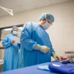 Surgical Technologist in the OP organizing a table of surgical instruments.