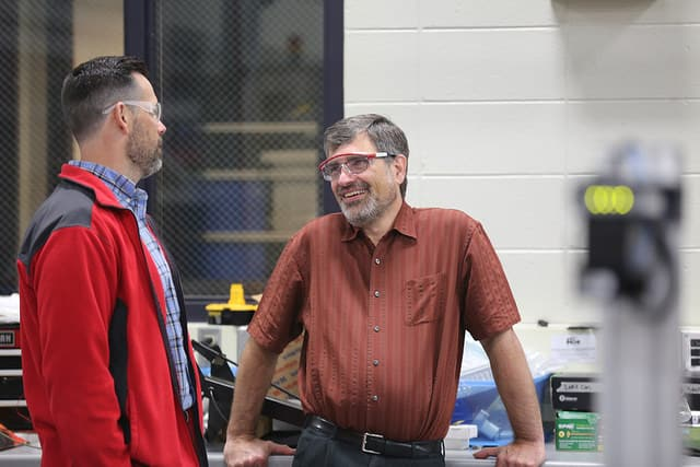 Jeff Quackenboss talking to another instructor in the manufacturing lab.