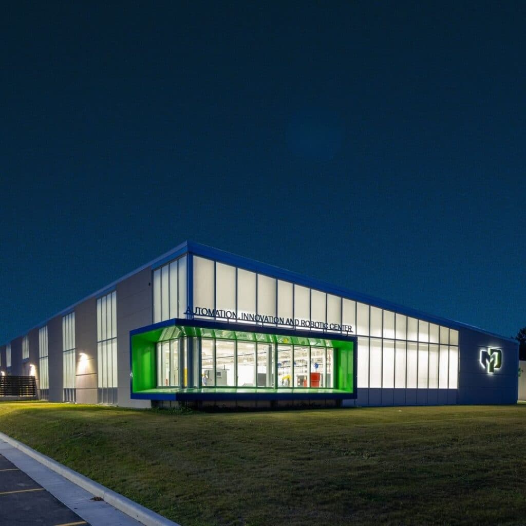 Moraine Park's new AIR Center at night. The lights inside shimmer into the dark night sky.